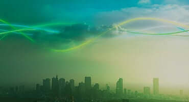 Buildings & clouds with rainbow waves.