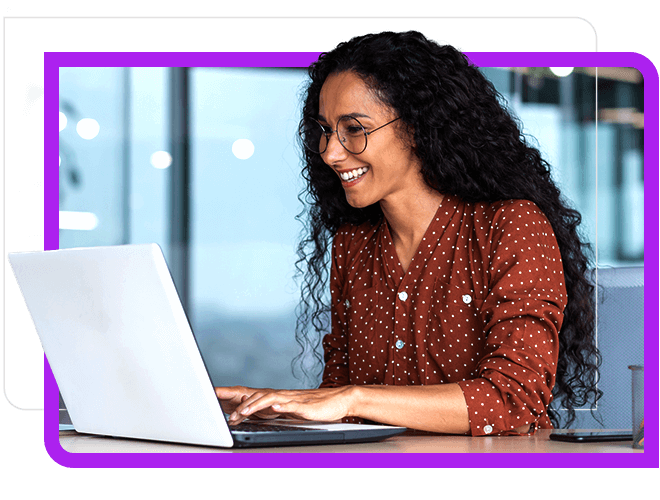 hispanic woman working and smiling at laptop