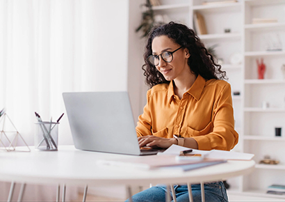 Lady Using Laptop Working Online Sitting In Office