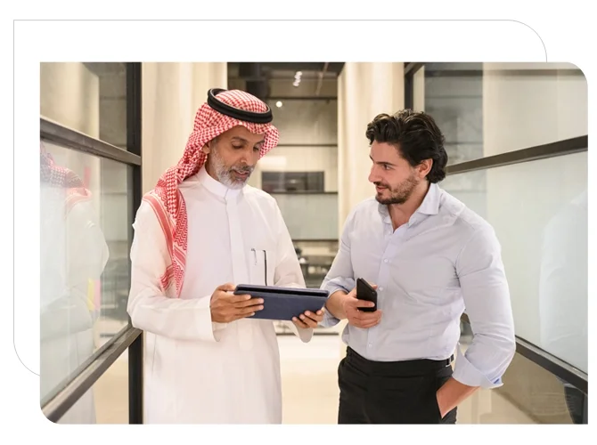 Arab men discussing while using tab